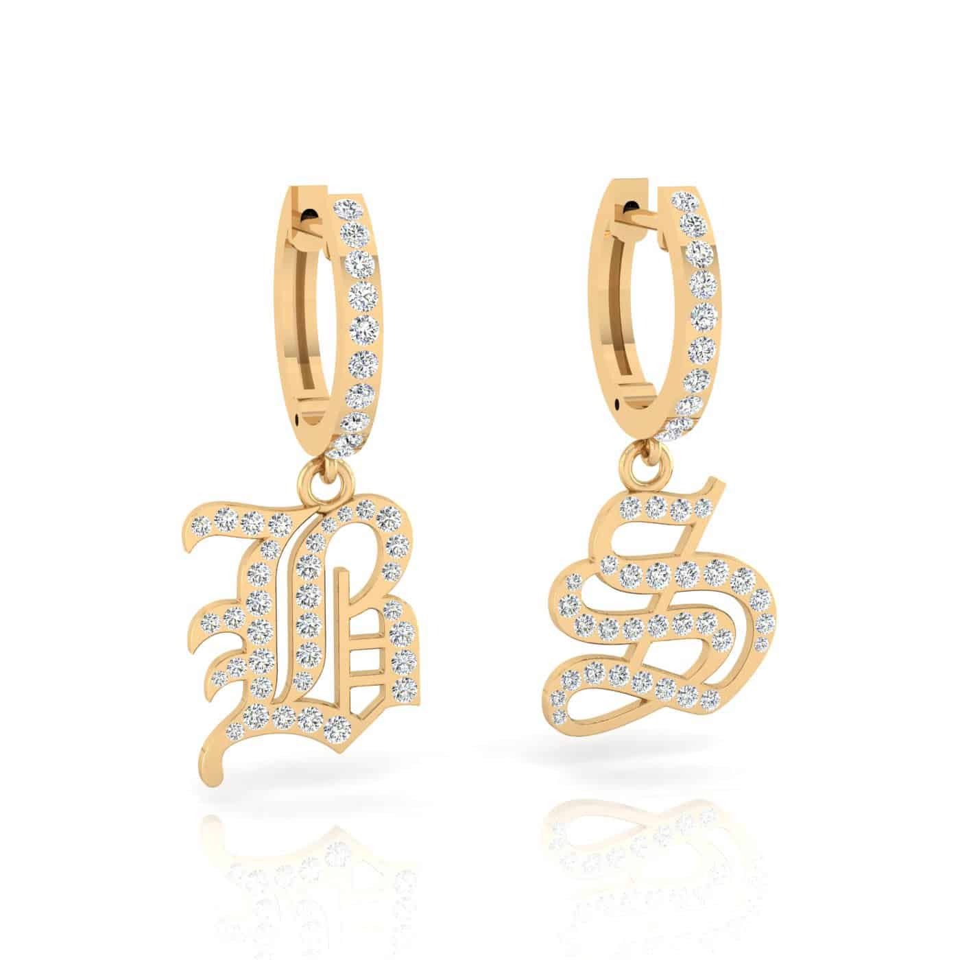 Adorn your ears with the Large Old English Initial Huggies—gold hoops featuring dangling letter charms, B and S, each encrusted with sparkling clear gemstones. The ornate Old English font gives these earrings a distinctive, customizable look for a personal touch. These elegant 14KT interchangeable huggies are perfect for any occasion.