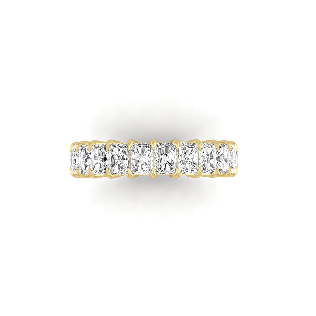 The Half Lab Grown Diamond Eternity Ring from Janet Heller Fine Jewelry, crafted in 18KT gold, features a row of evenly spaced diamonds offered in various shapes and custom carat weights. The color of the diamonds is F and the clarity is VS. This is the perfect wedding band to be worn alone or stacked with your engagement ring.