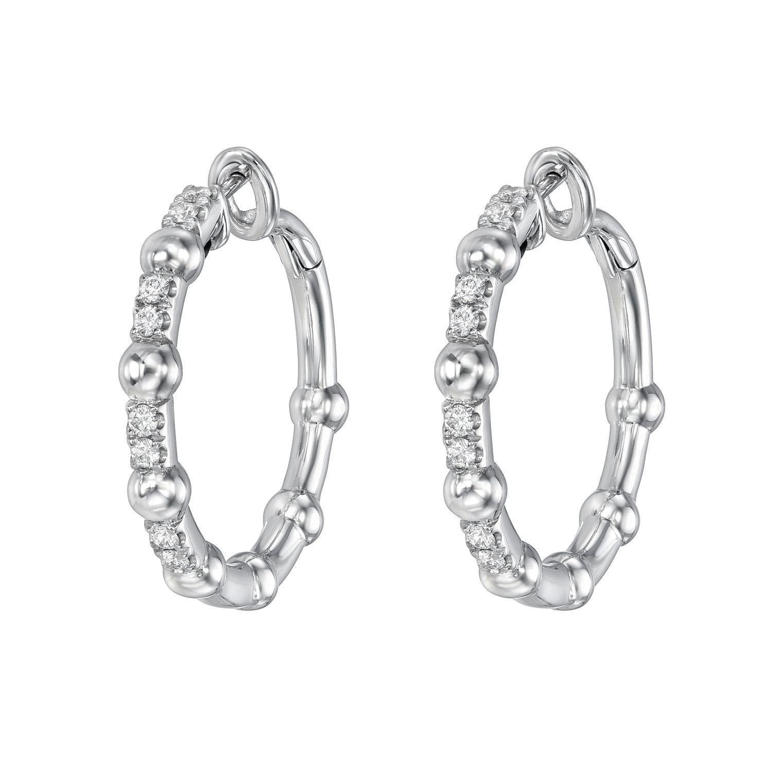 A pair of Diamond Celeste Hoops featuring evenly spaced small round beads and sparkling clear gemstones set along part of each silver hoop.