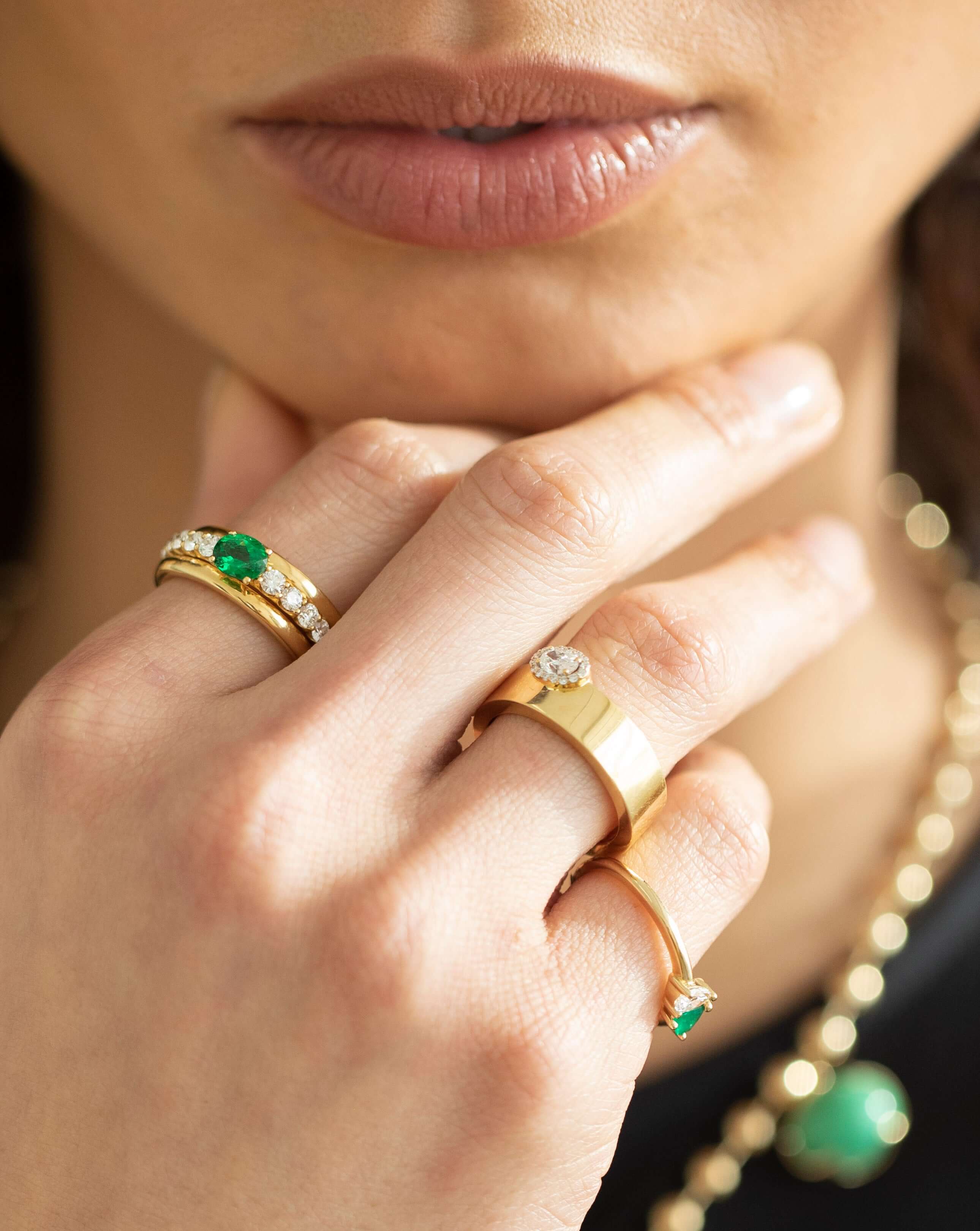 The Diamond Oval Cut Ring from Janet Heller Fine Jewelry is crafted in 18KT gold. The ring features an oval diamond surrounded by several smaller diamonds.