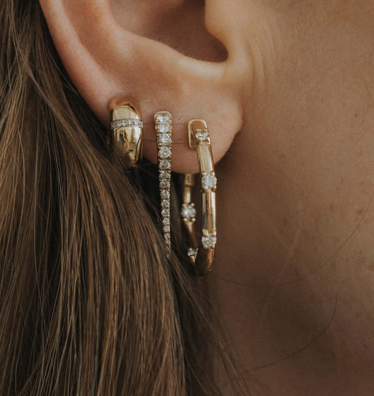 The Diamond In & Out Hoops from Janet Heller Fine Jewelry are crafted in 14KT gold. The earrings are studded with round diamonds. The hoops can be worn alone or layered along the ear with other earrings.
