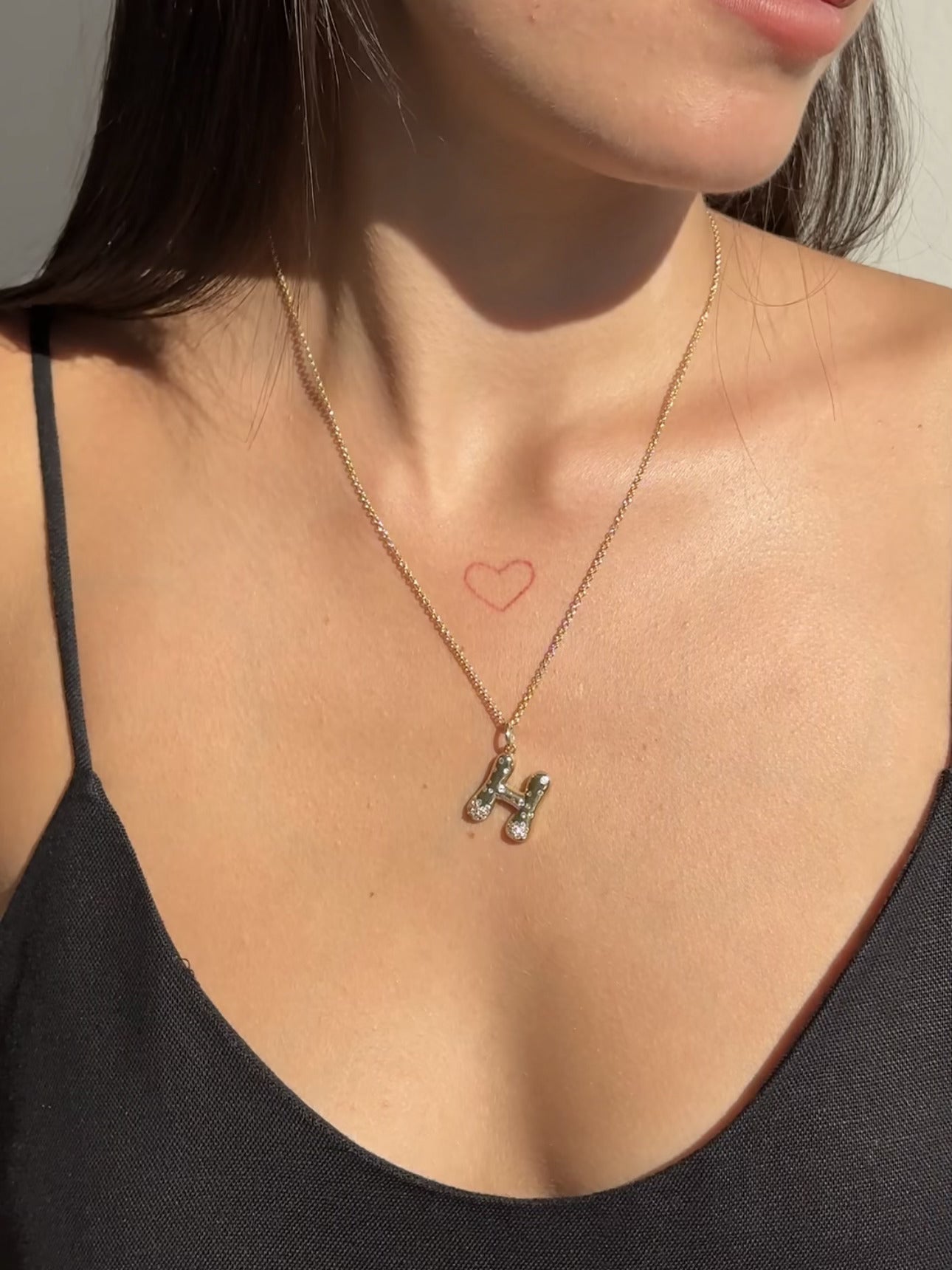 The Large Mosaic Diamond Letter Charm from Janet Heller Fine Jewelry is crafted in 14KT gold.  The pendant features a sprinkling of diamonds.   The clasp clips easily onto various Janet Heller Fine Jewelry chains and necklaces.