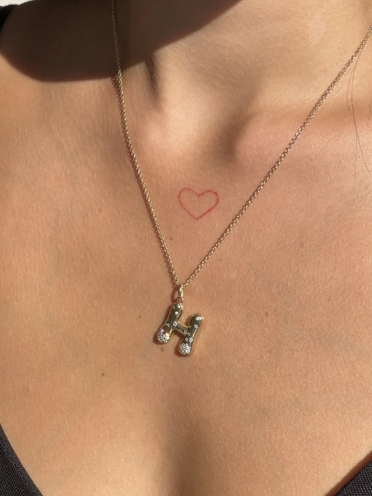 The Large Mosaic Diamond Letter Charm from Janet Heller Fine Jewelry is crafted in 14KT gold.  The pendant features a sprinkling of diamonds.   The clasp clips easily onto various Janet Heller Fine Jewelry chains and necklaces.