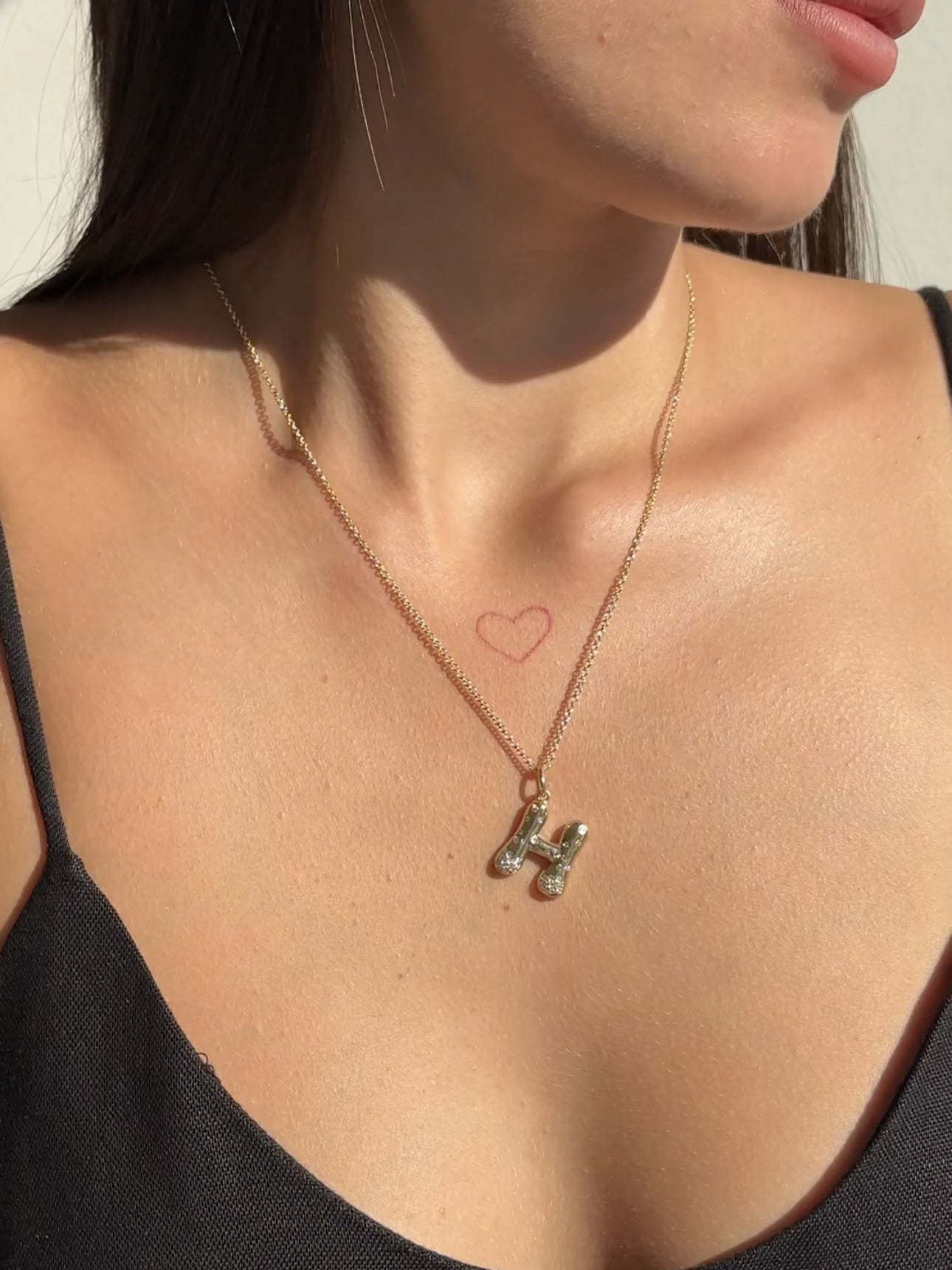 The Large Mosaic Diamond Letter Charm from Janet Heller Fine Jewelry is crafted in 14KT gold.  The pendant features a sprinkling of diamonds.   The clasp clips easily onto various Janet Heller Fine Jewelry chains and necklaces.