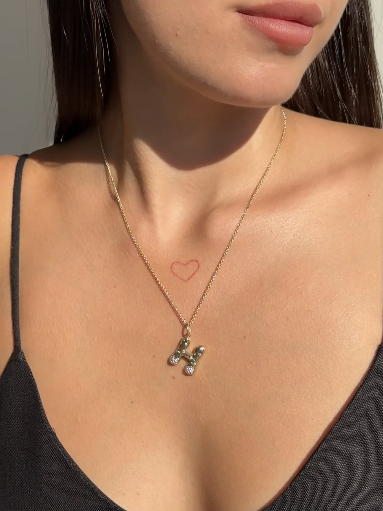The Large Mosaic Diamond Letter Charm from Janet Heller Fine Jewelry is crafted in 14KT gold.  The pendant features a sprinkling of diamonds.   The clasp clips easily onto various Janet Heller Fine Jewelry chains and necklaces.