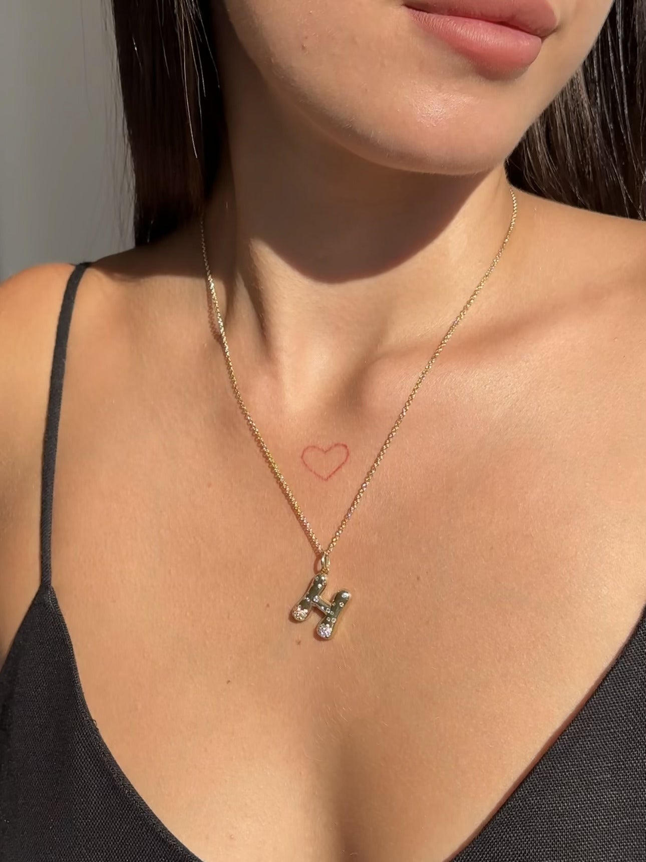 The Large Mosaic Diamond Letter Charm from Janet Heller Fine Jewelry is crafted in 14KT gold.  The pendant features a sprinkling of diamonds.   The clasp clips easily onto various Janet Heller Fine Jewelry chains and necklaces.