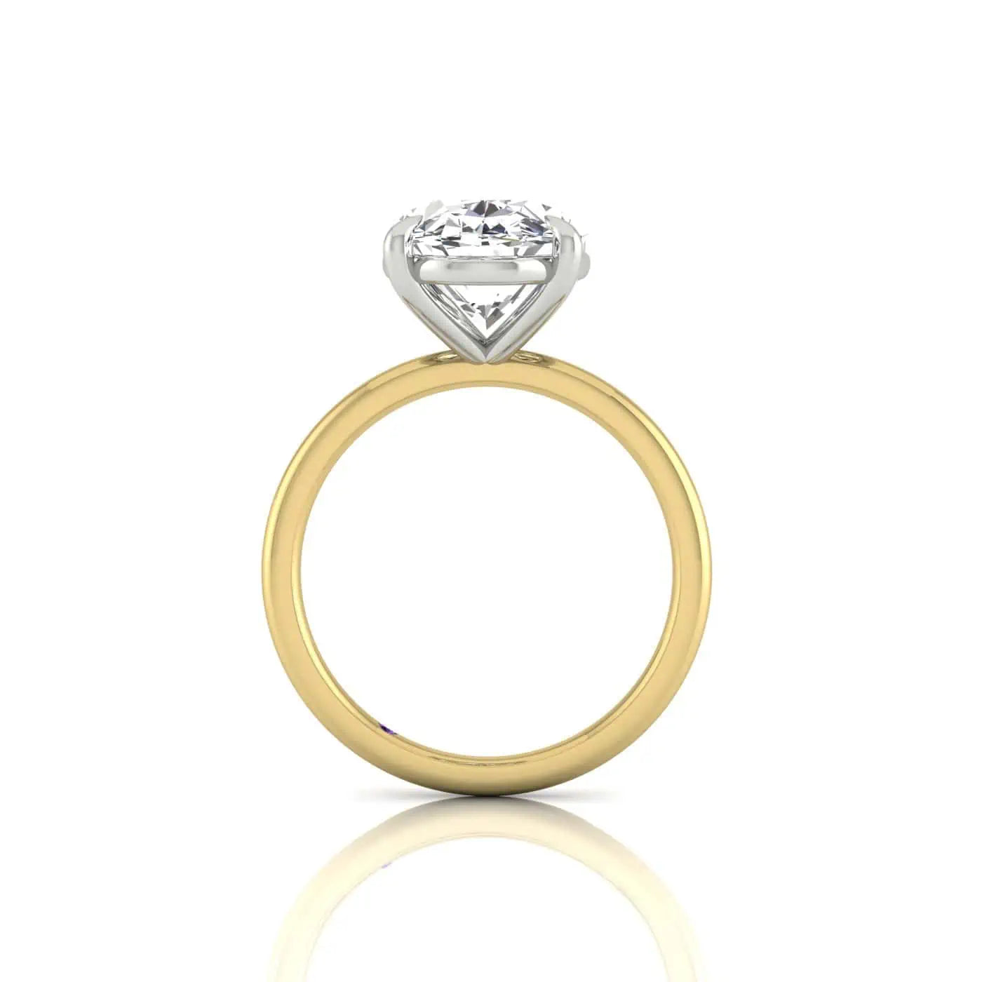 The Solitaire is an exquisite 18KT gold ring featuring a large, round diamond in a solitaire setting. Its upright display allows the diamond to sparkle prominently atop its simple yet elegant design, set against a plain white background.