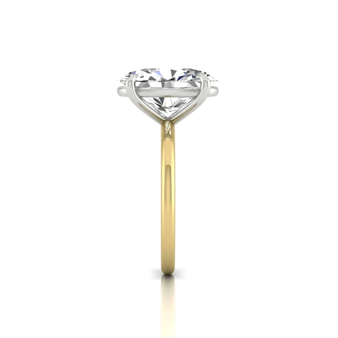 The Solitaire ring features a heart-shaped diamond in white gold or platinum prongs, beautifully set on an 18KT yellow gold band. Displayed vertically against a white background, it exudes timeless elegance.