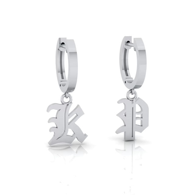 Two Small Old English Initial Huggies in silver with dangling Gothic letters K and B. These unique earrings are perfect for pairing with diamonds or wearing alone, elegantly showcased against a white background.
