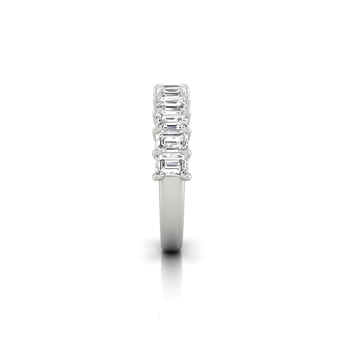 Side view of the Half Diamond Eternity Ring in 18KT white gold, showcasing six vertically set rectangular emerald-cut diamonds with VS clarity. The elegant piece is highlighted against a plain white background, emphasizing its timeless beauty.