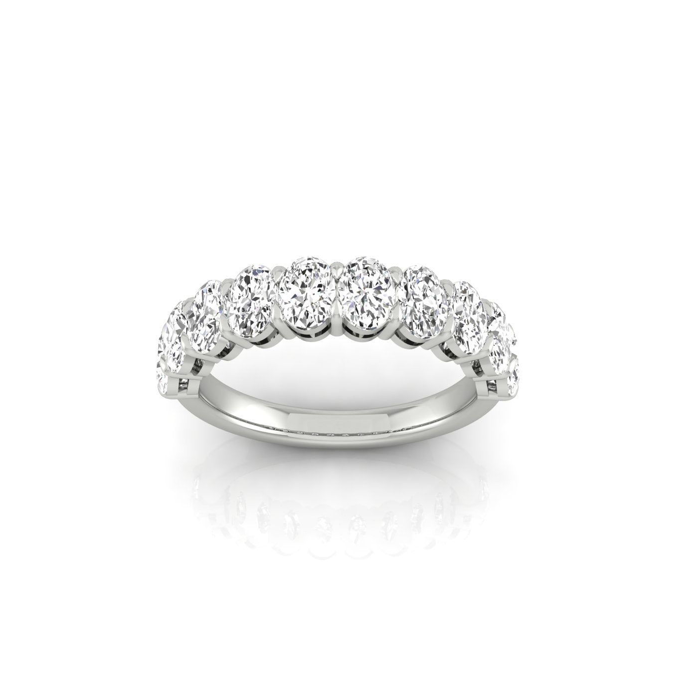 The Half Diamond Eternity Ring is a silver band featuring a row of round, sparkling diamonds with VS Clarity set across the top, showcased against a plain white background that highlights its elegant design and brilliance.