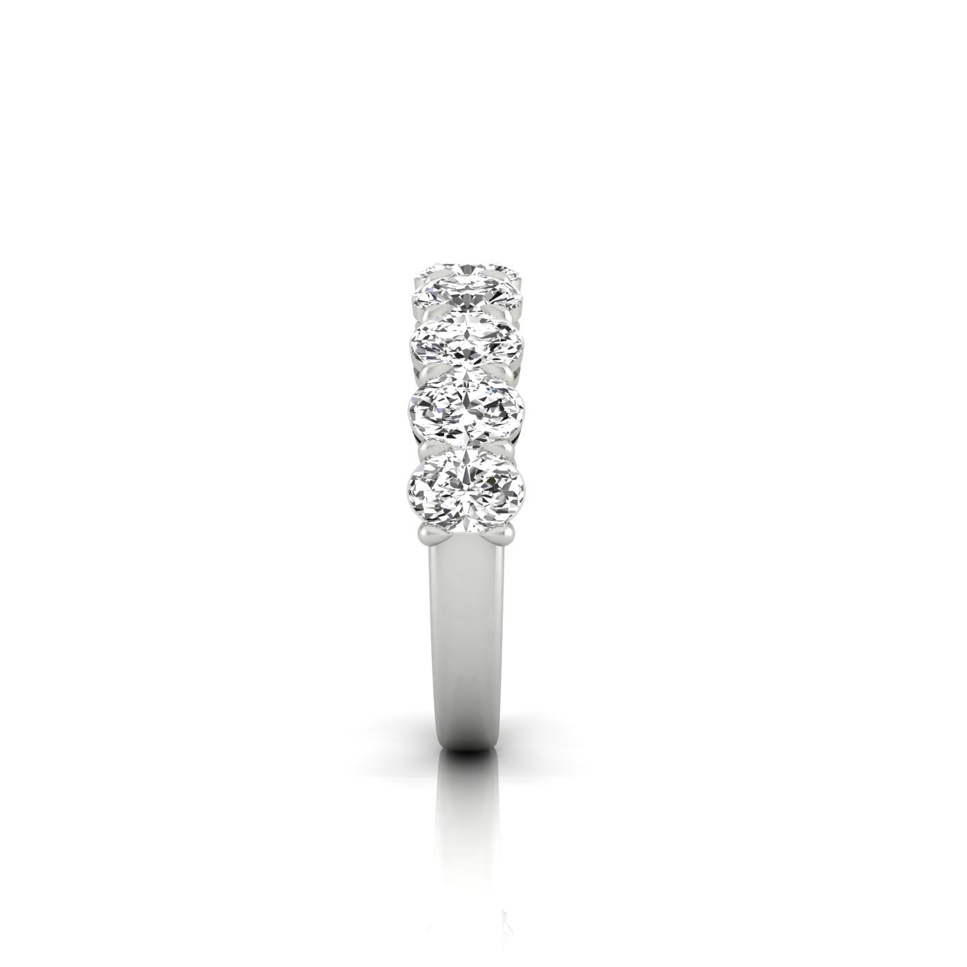 Side view of the Half Diamond Eternity Ring, a silver band with five round VS clarity diamonds set along the top, shining against a white background.