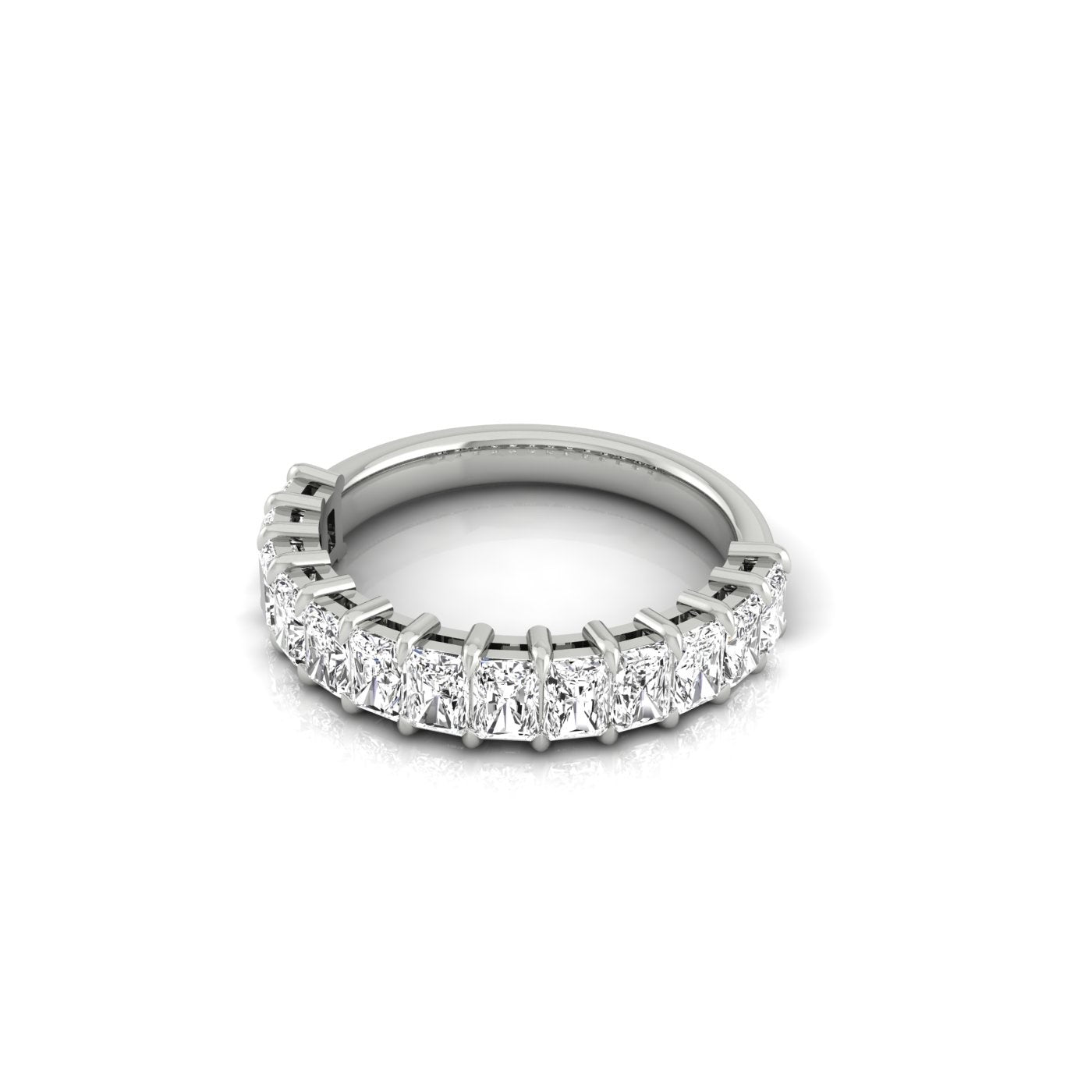 The Half Diamond Eternity Ring is a silver band adorned with a row of dazzling white gemstones in a prong setting and VS Clarity. Its smooth, reflective surface enhances elegance against its plain white background, complementing any ensemble.
