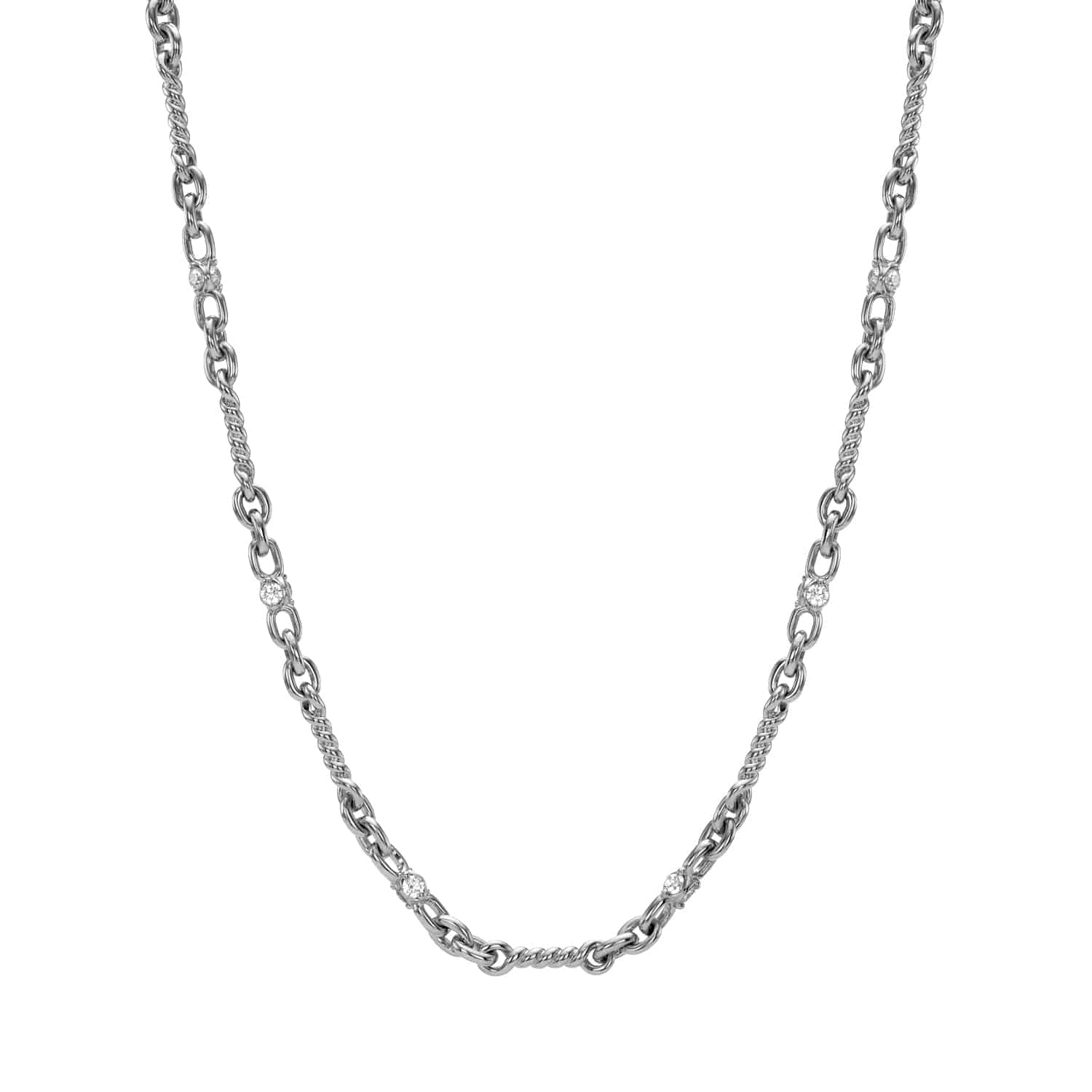 The Diamond Belle Necklace by janethellerfinejewelry features a silver chain with interlocking oval links, small textured sections, and shiny accents. This fine jewelry piece balances smooth and detailed elements for a stylish, elegant look.