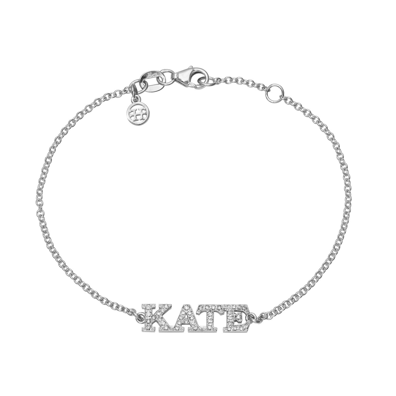 The Diamond Block Name Bracelet showcases a silver chain with a nameplate engraved KATE in capitals, adorned with crystals. It features a lobster clasp and a round charm near the fastening.