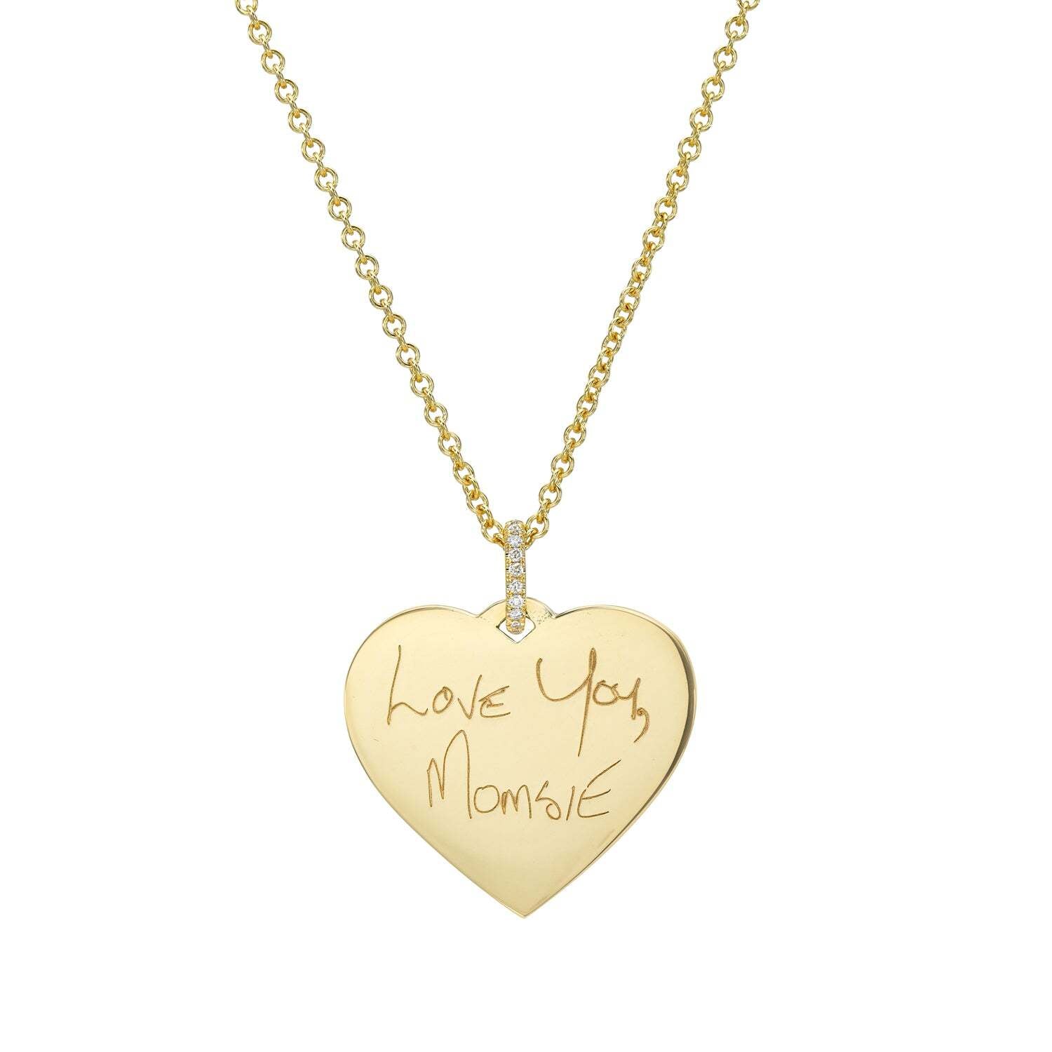 The Large Heart Engravable Pendant Necklace is a gold, heart-shaped piece adorned with a delicate row of diamonds above the loop and engraved with the handwritten message “Love You, Momgie.” This exquisite handwriting jewelry transforms your personal message into a cherished keepsake she’ll treasure forever.