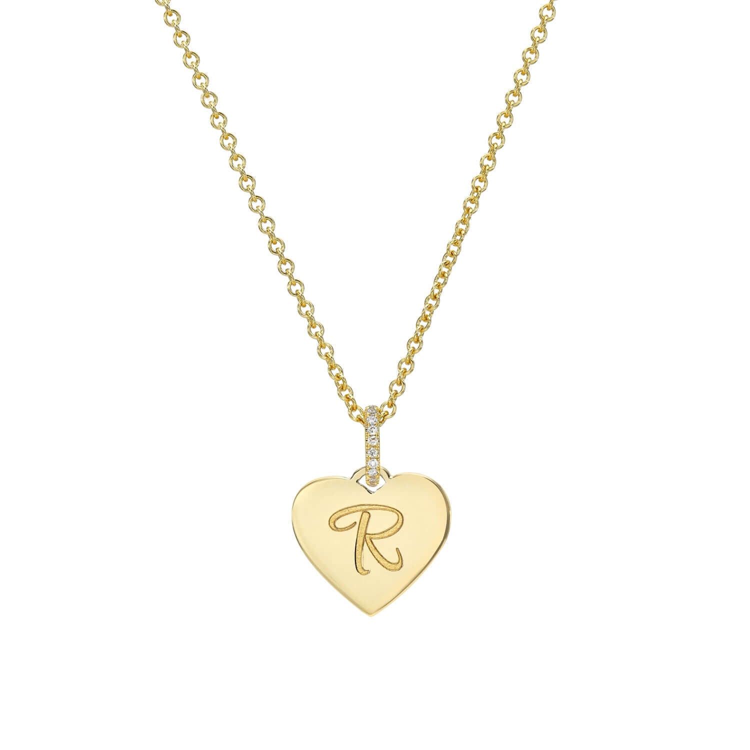 The Mini Heart Engravable Pendant Necklace from the Sketch Collection features a heart-shaped pendant engraved with the letter R. It hangs gracefully from a thin gold chain, embellished with small crystals near the clasp.