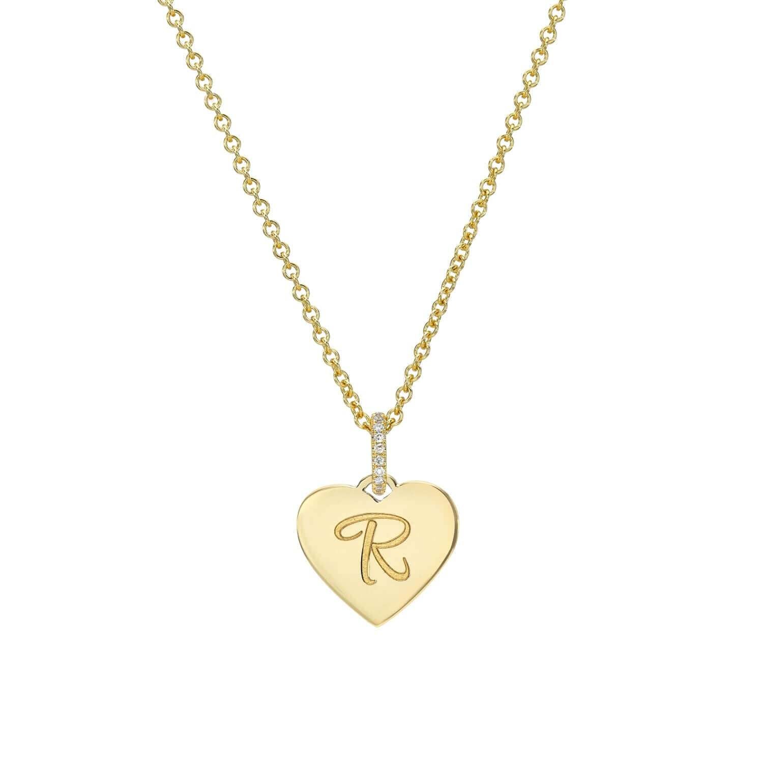 Part of the Sketch Collection, the Mini Heart Engravable Pendant Necklace from Janet Heller Fine Jewelry is crafted in 14KT gold. The necklace features a delicate chain with a diamond-studded loop and a heart-shaped charm perfect for engraving a personalized message.