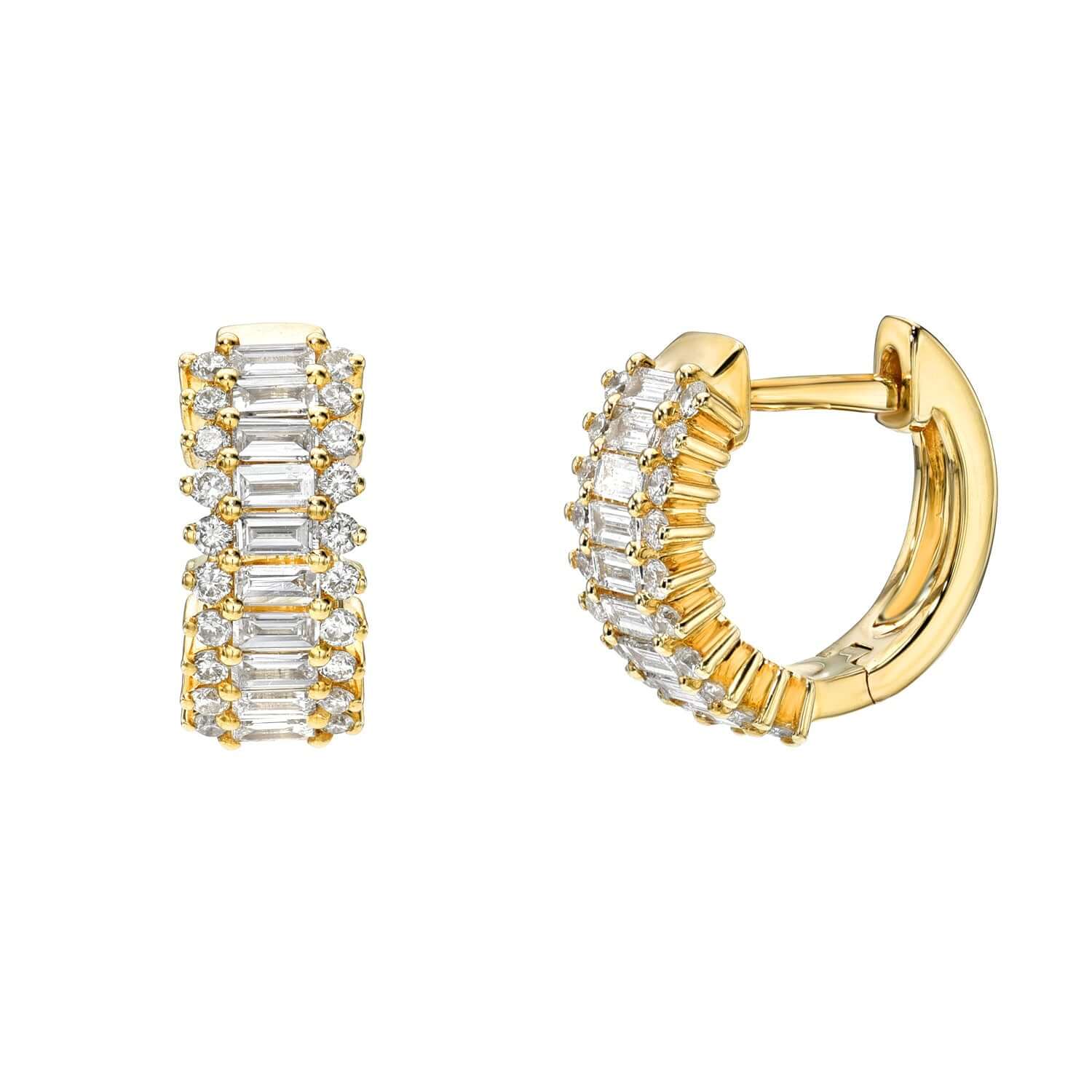 The Baguette Diamond June Huggies from Janet Heller Fine Jewelry are crafted in 14KT gold. The earrings showcase rows of baguette-cut and round diamonds. The huggies can be worn alone or layered along the ear with other earrings.