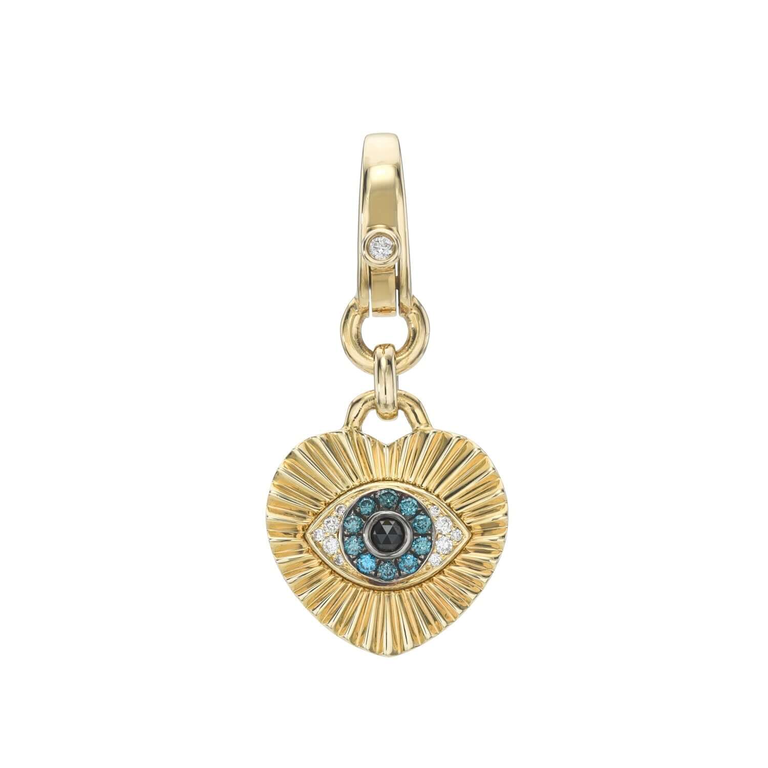 Explore the Ribbed Diamond Heart Evil Eye Charm from Janet Heller Fine Jewelry, a gold heart-shaped pendant with a textured surface and a central blue and white eye design, adorned with charms and a small crystal, all hanging beautifully from a gold loop.