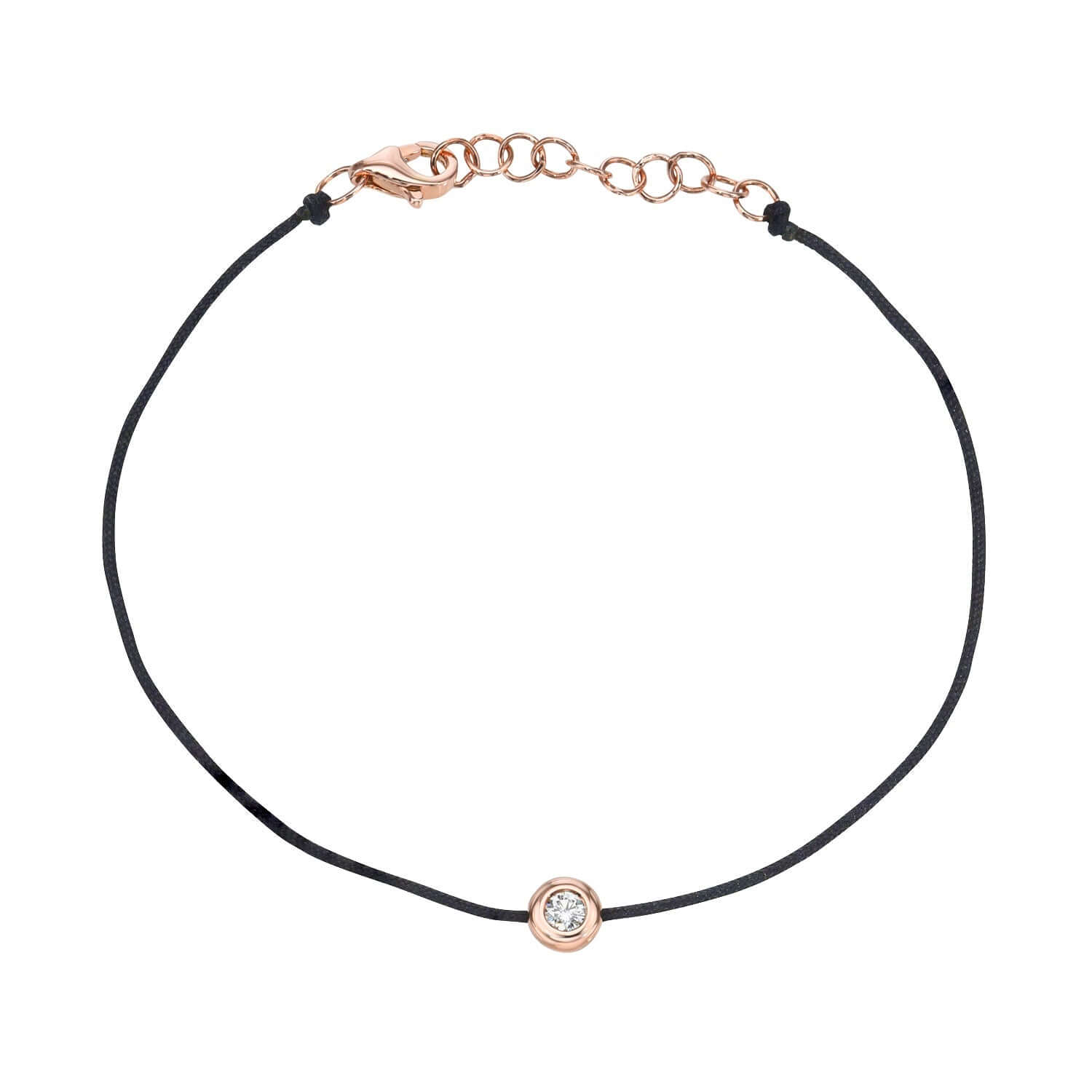 The Black Round Diamond Cord Bracelet from Janet Heller Fine Jewelry is crafted in 14KT gold.  The string bracelet features a single diamond in a bezel setting with an adjustable chain.  The bracelet can be stacked or worn alone.