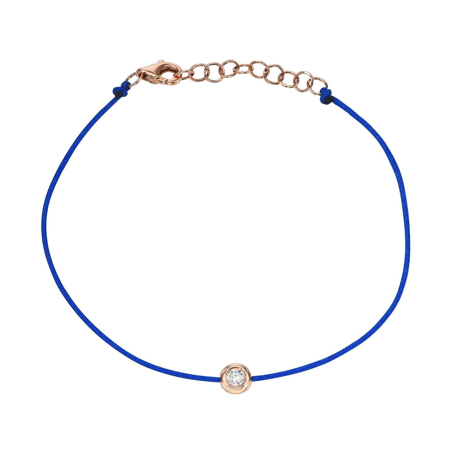 Explore the sophistication of the Cobalt Blue Round Diamond Cord Bracelet by Janet Heller Fine Jewelry. Featuring a thin blue cord, a small round gold setting with a clear gemstone, and an adjustable chain with a gold clasp, its perfect for personalized style. Contact us for more details.