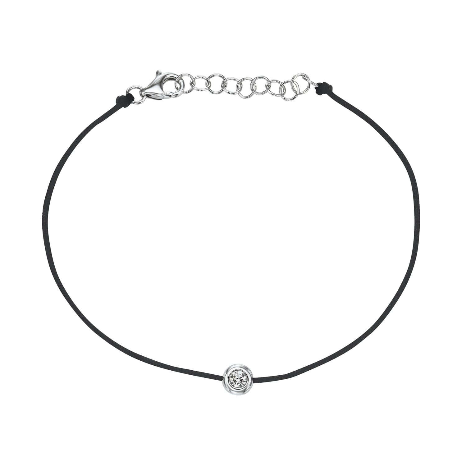 The Black Round Diamond Cord Bracelet from Janet Heller Fine Jewelry is crafted in 14KT gold.  The string bracelet features a single diamond in a bezel setting with an adjustable chain.  The bracelet can be stacked or worn alone.