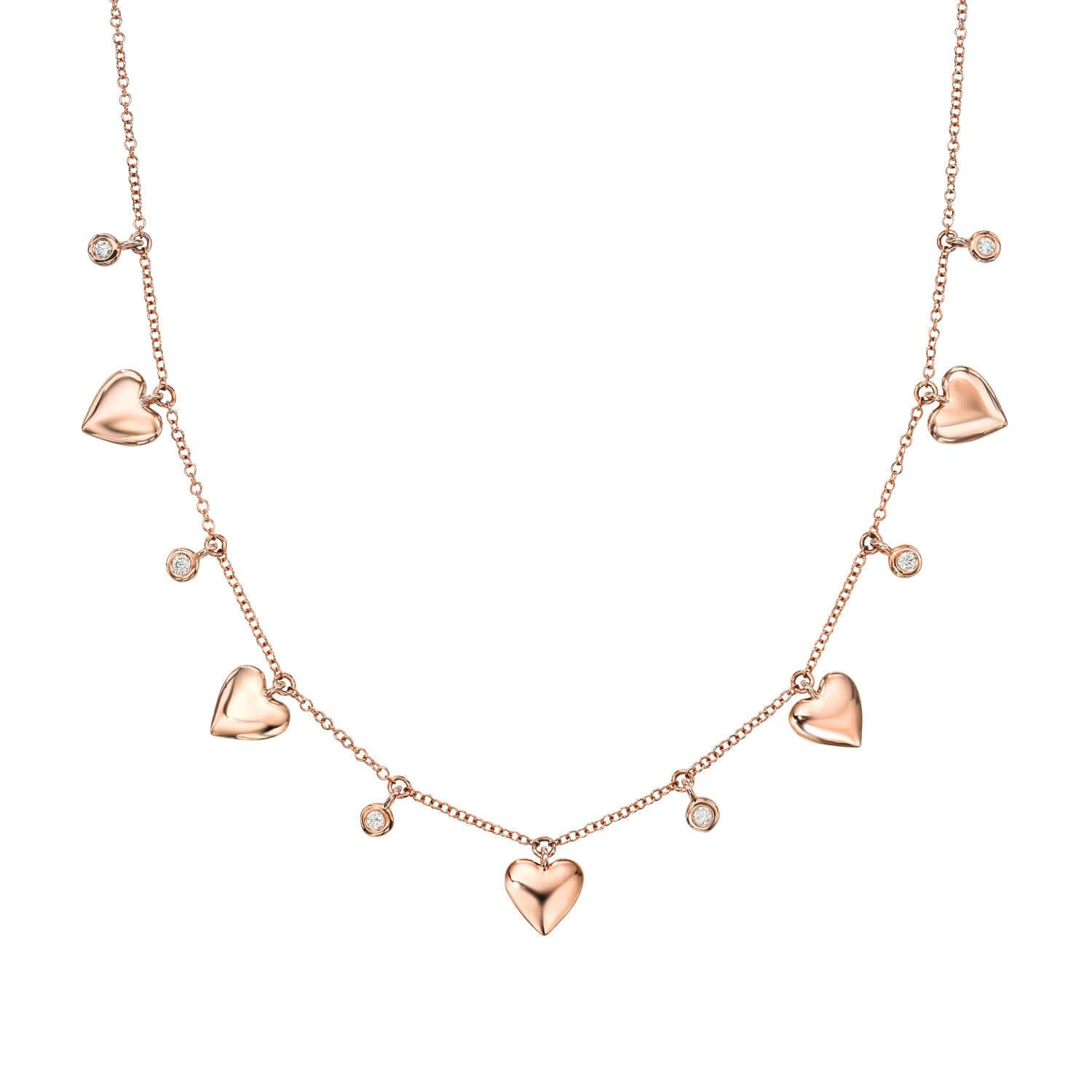 The Naya Heart Necklace by Janet Heller Fine Jewelry features five heart-shaped charms and five small round gems evenly spaced along a delicate rose gold chain, elegantly displayed on a white background.