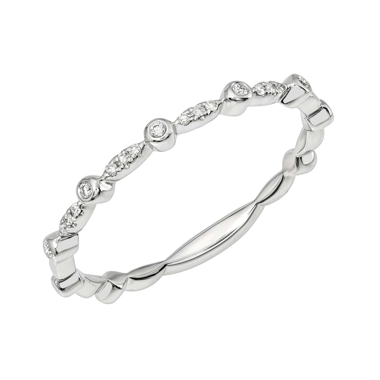 The Scalloped Diamond Bezel Ring from Janet Heller Fine Jewelry is a delicate white gold ring featuring small round diamonds set in alternating bezels and prongs along a thin, twisted band. This preorder ring is available in your preferred size.