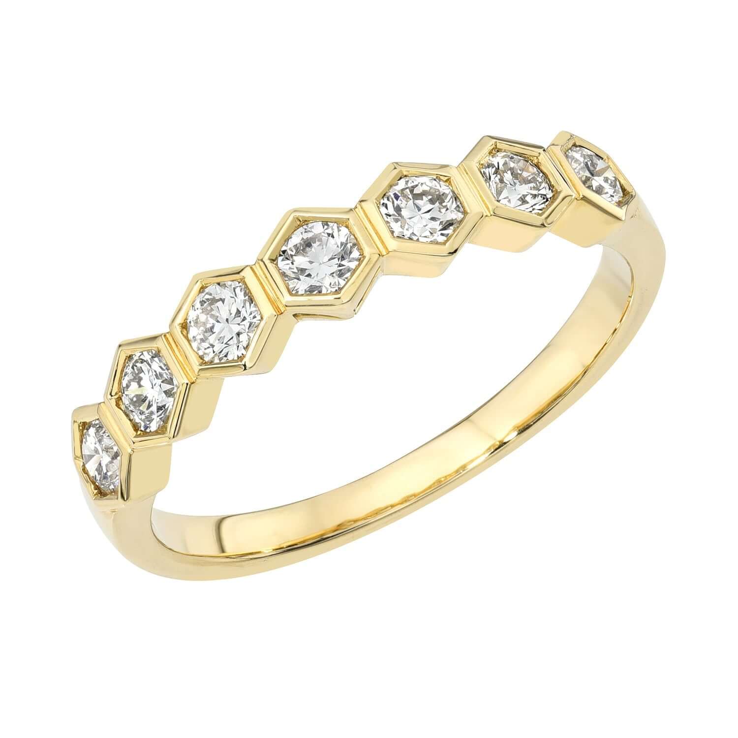 The Diamond Honeycomb Stacking Ring from Janet Heller Fine Jewelry is crafted in 14KT gold. The band features a hexagonal settings, each holding a round diamond. The ring can be stacked or worn on its own.