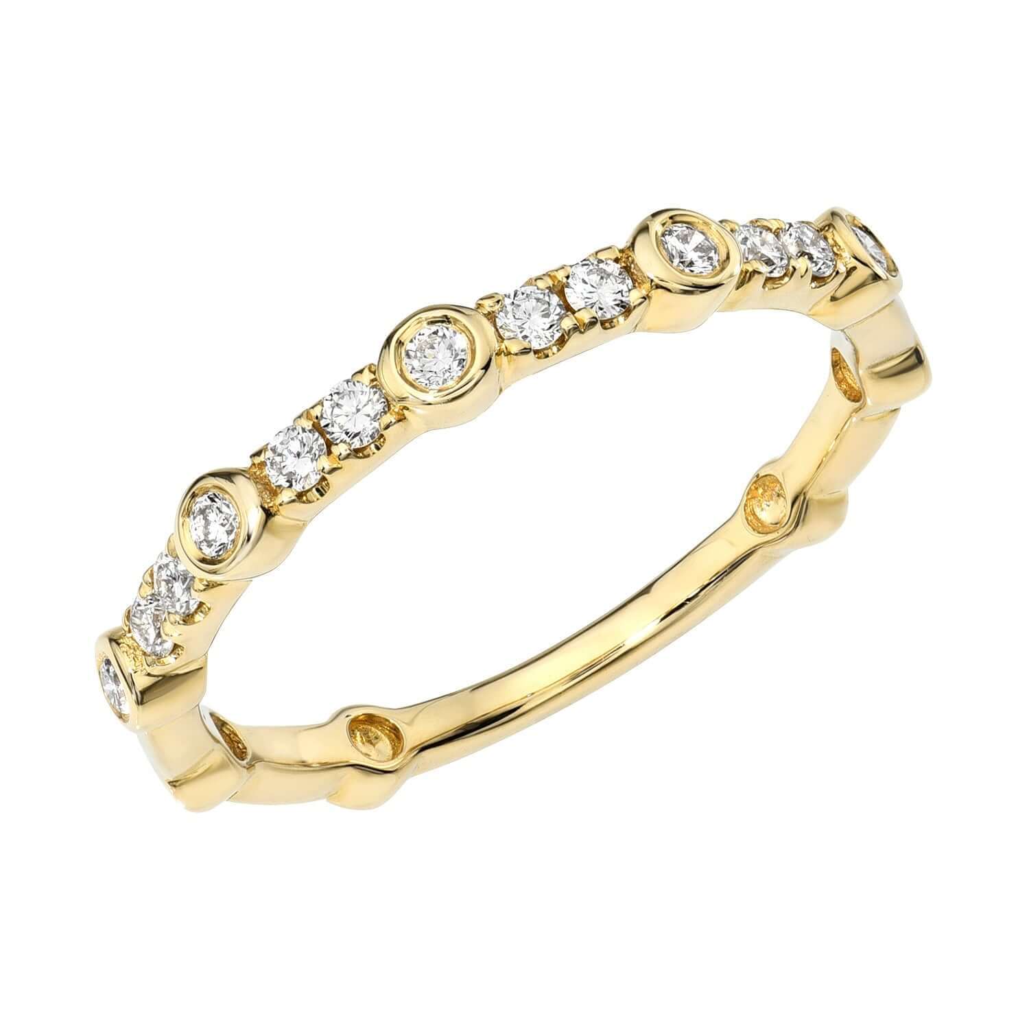 The Diamond Quincy Ring from Janet Heller’s fine jewelry collection features round-cut diamonds set in a repeating bezel and prong pattern around the band, elegantly displayed against a white background. This exquisite piece is available for preorder.