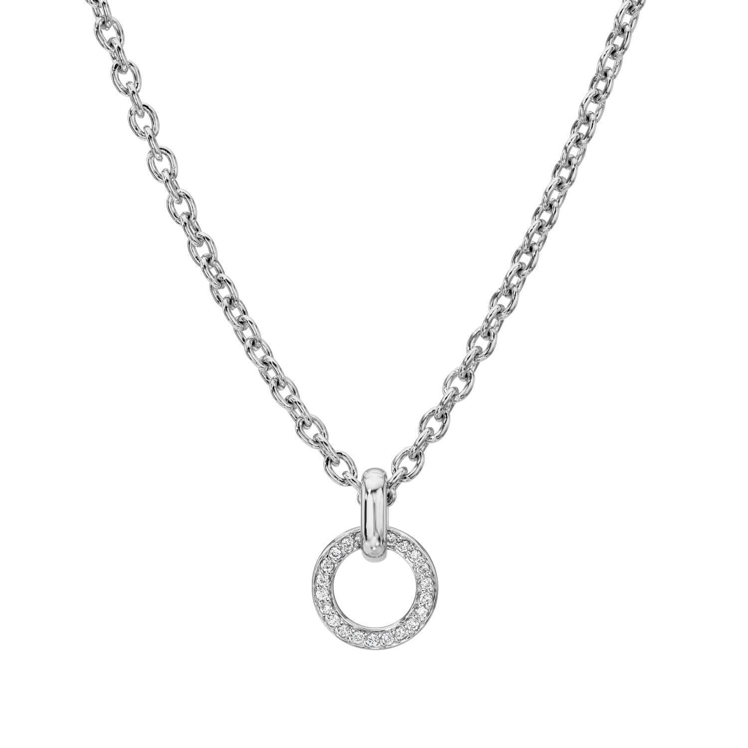 The Diamond Barcelona Necklace by Janet Heller Fine Jewelry features a silver chain with a small, round pendant set with sparkling stones, shown against a plain white background.