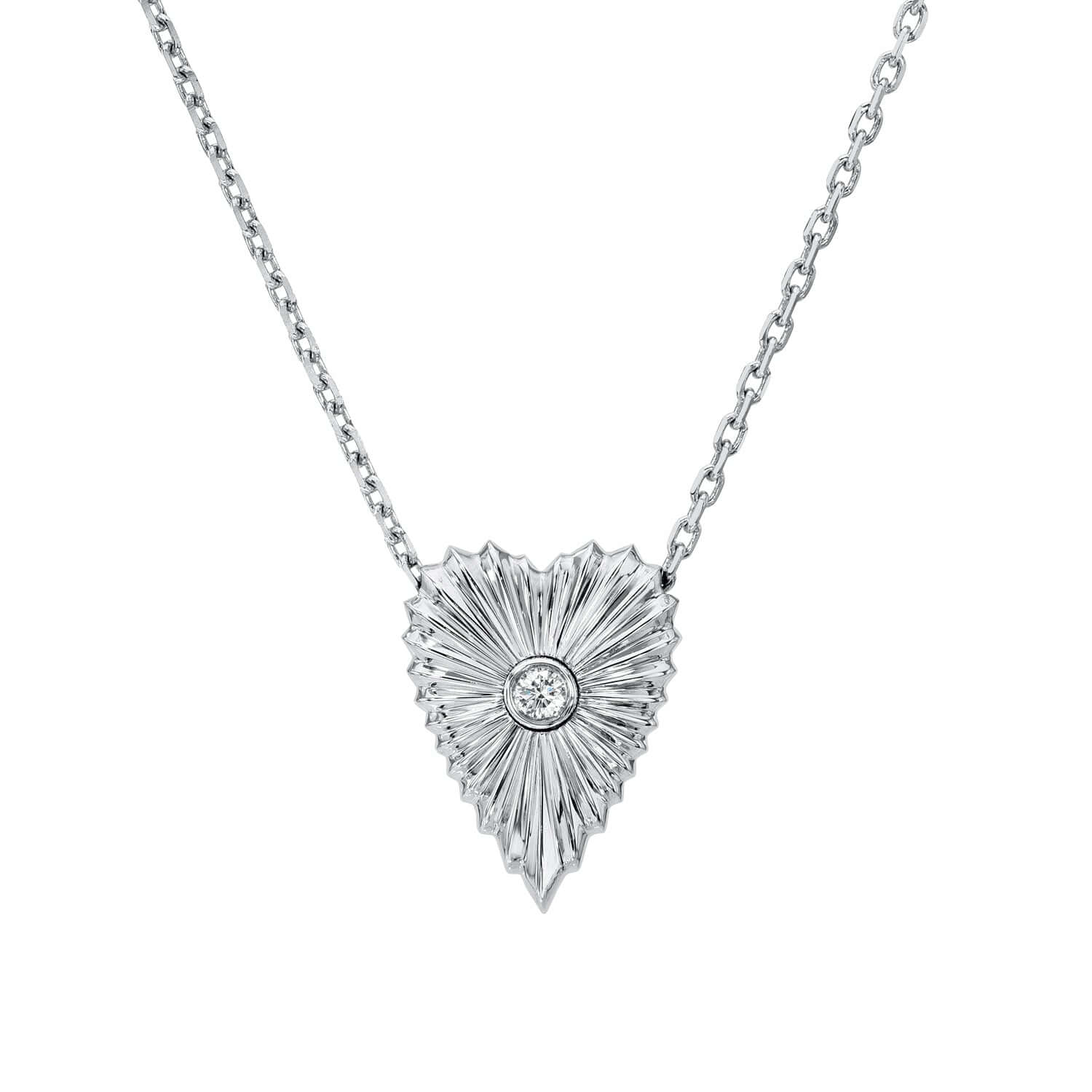 The Diamond Elongated Heart Ribbed Necklace from Janet Heller Fine Jewelry is crafted in 14KT gold. The delicate chain features a diamond heart-shaped pendant with a sunburst design and central round diamond. The necklace can be worn alone or layered with other necklaces.