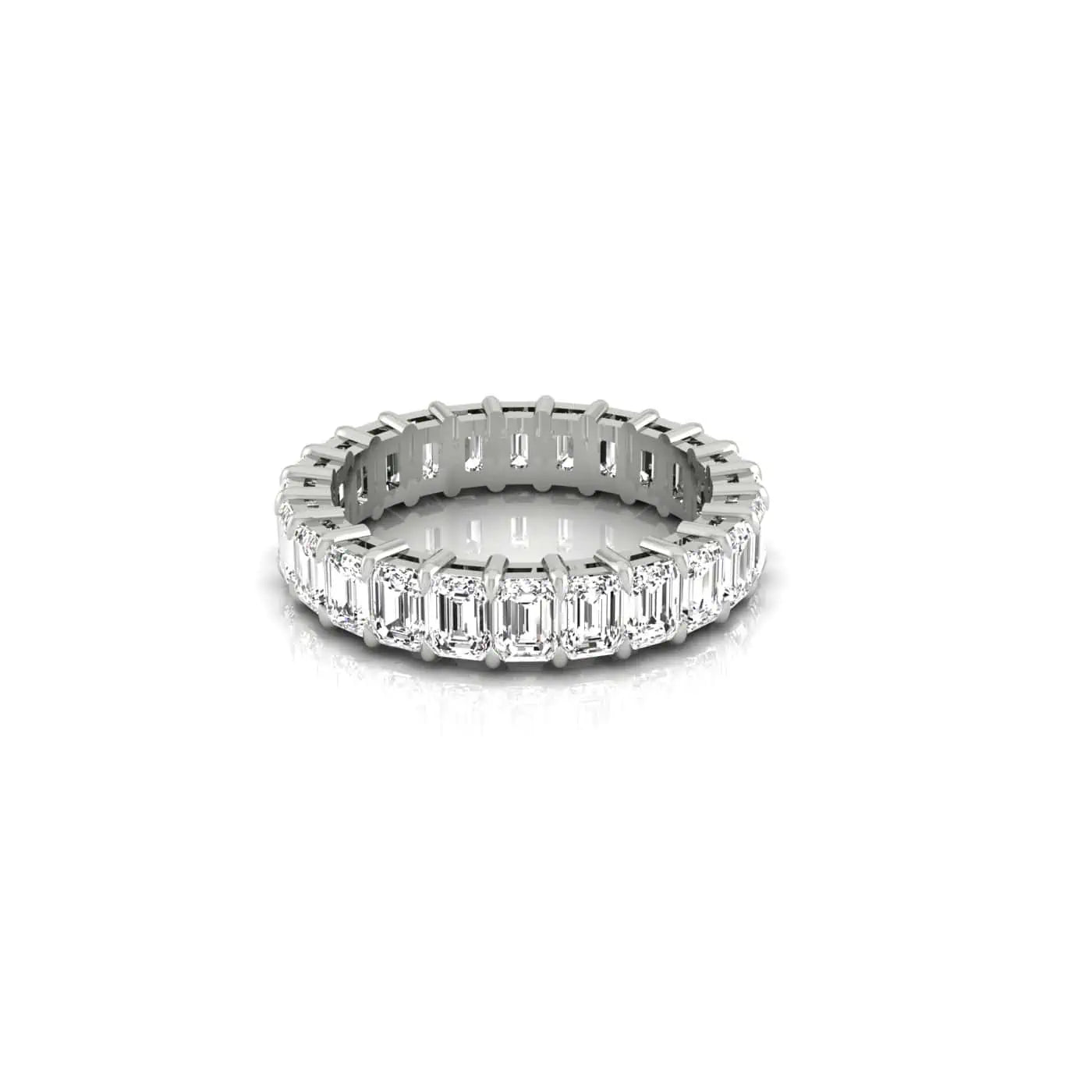 The Full Diamond Eternity Ring features emerald-cut diamonds with VS clarity and F color set in silver, encircling the entire 18KT gold band, reflecting light for a radiant sparkle.