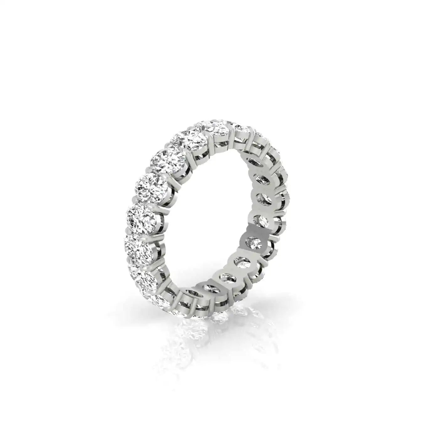 The Full Diamond Eternity Ring from Janet Heller Fine Jewelry, crafted in 18KT gold, features evenly spaced diamonds offered in various shapes and custom carat weights. The color of the diamonds is F and the clarity is VS. This is the perfect wedding band to be worn alone or stacked with your engagement ring.