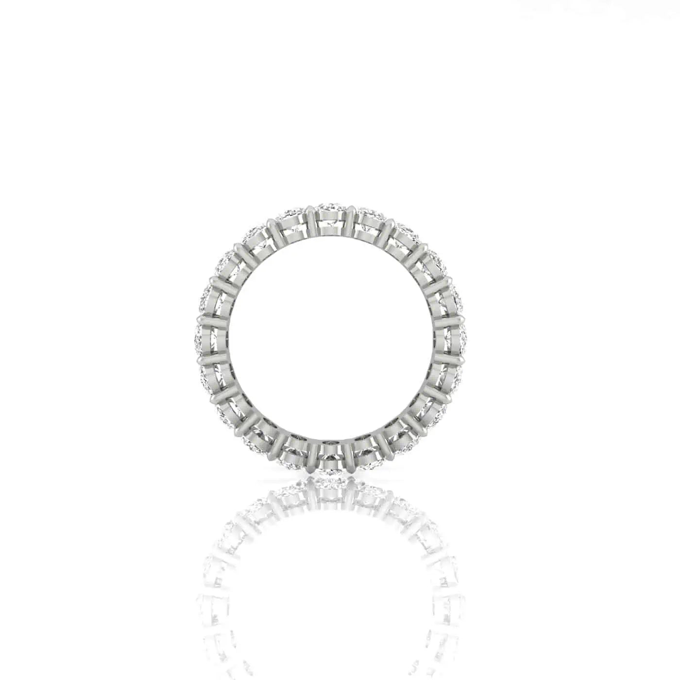 The Full Diamond Eternity Ring from Janet Heller Fine Jewelry, crafted in 18KT gold, features evenly spaced diamonds offered in various shapes and custom carat weights. The color of the diamonds is F and the clarity is VS. This is the perfect wedding band to be worn alone or stacked with your engagement ring.