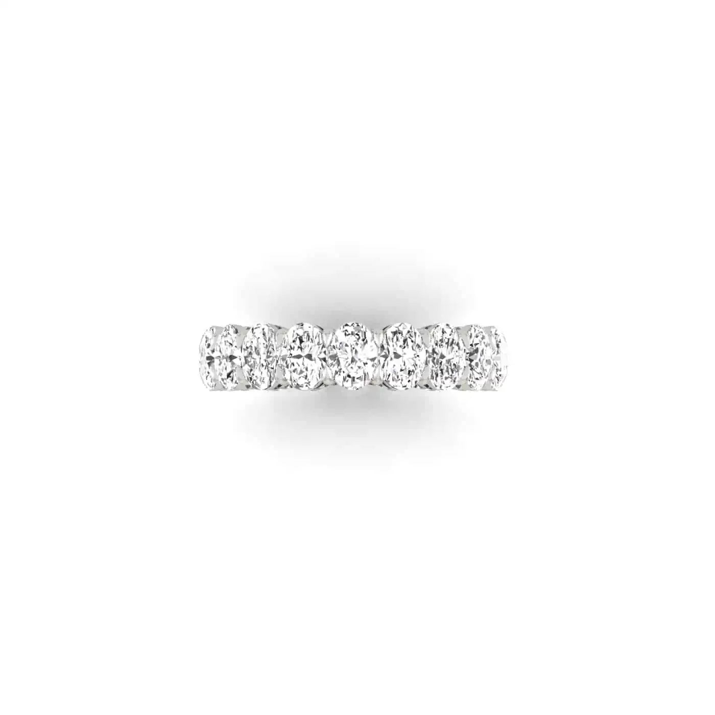 The Full Diamond Eternity Ring from Janet Heller Fine Jewelry, crafted in 18KT gold, features evenly spaced diamonds offered in various shapes and custom carat weights. The color of the diamonds is F and the clarity is VS. This is the perfect wedding band to be worn alone or stacked with your engagement ring.