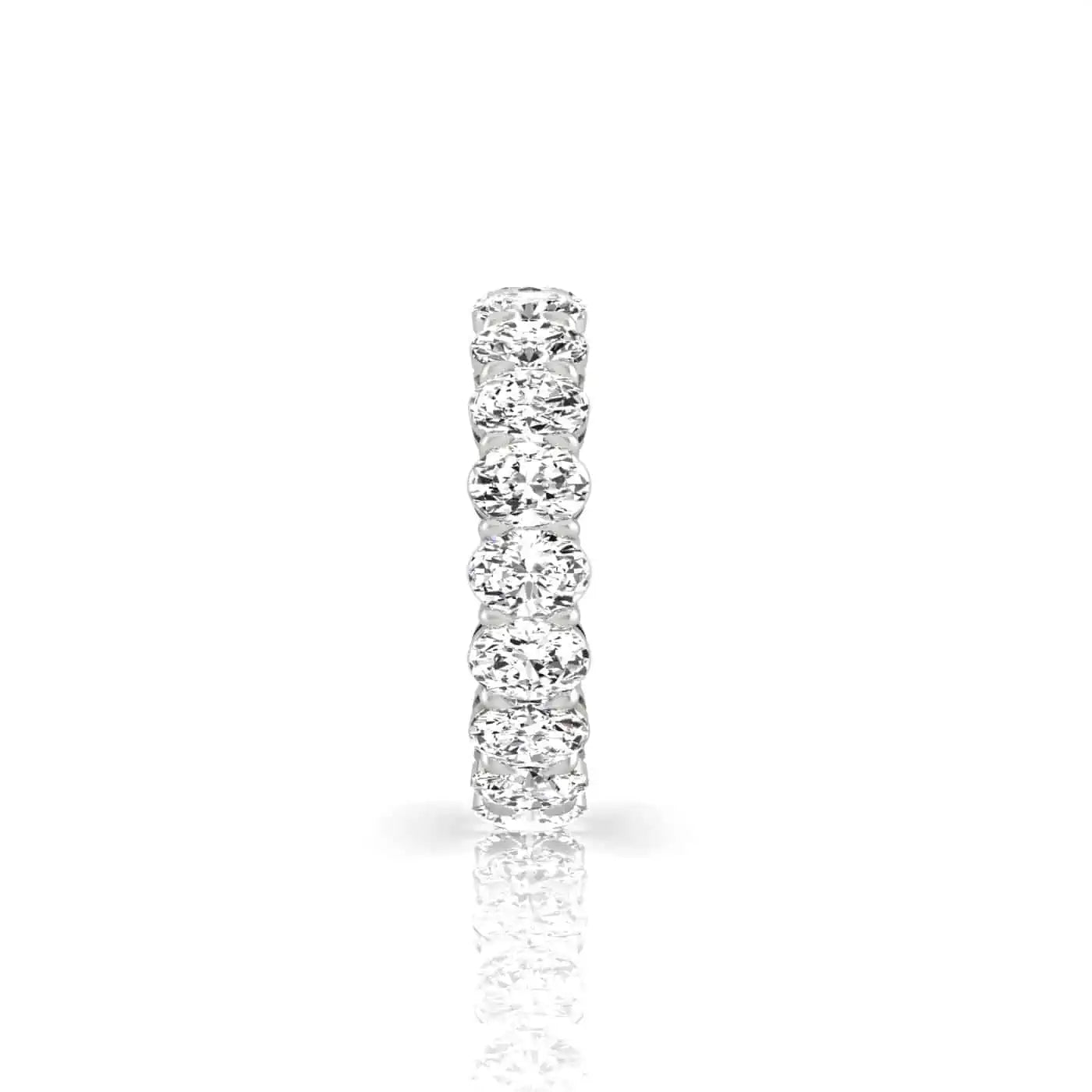The Full Diamond Eternity Ring from Janet Heller Fine Jewelry, crafted in 18KT gold, features evenly spaced diamonds offered in various shapes and custom carat weights. The color of the diamonds is F and the clarity is VS. This is the perfect wedding band to be worn alone or stacked with your engagement ring.