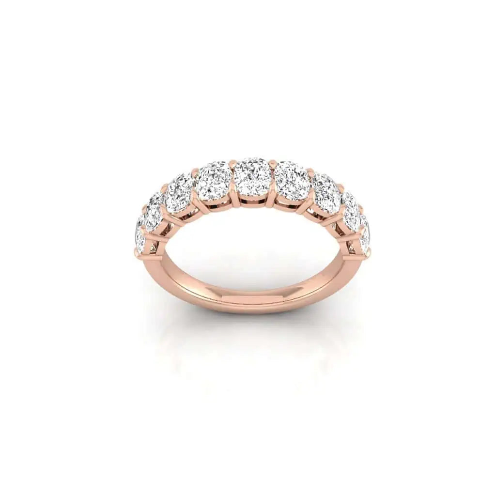 The Half Diamond Eternity Ring, made from 18KT rose gold, showcases a row of round diamonds with VS clarity against a white background.