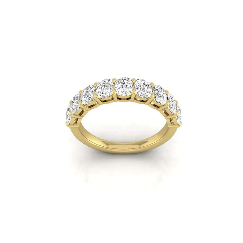 The Half Diamond Eternity Ring, crafted with 18KT gold and round-cut diamonds of VS clarity, is elegantly showcased against a plain white background.