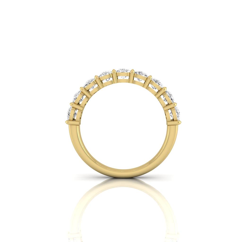 The Half Lab Grown Diamond Eternity Ring features a row of sparkling lab-grown diamonds set in 18KT gold. Positioned upright against a white background, it showcases its intricate side profile with a faint reflection.