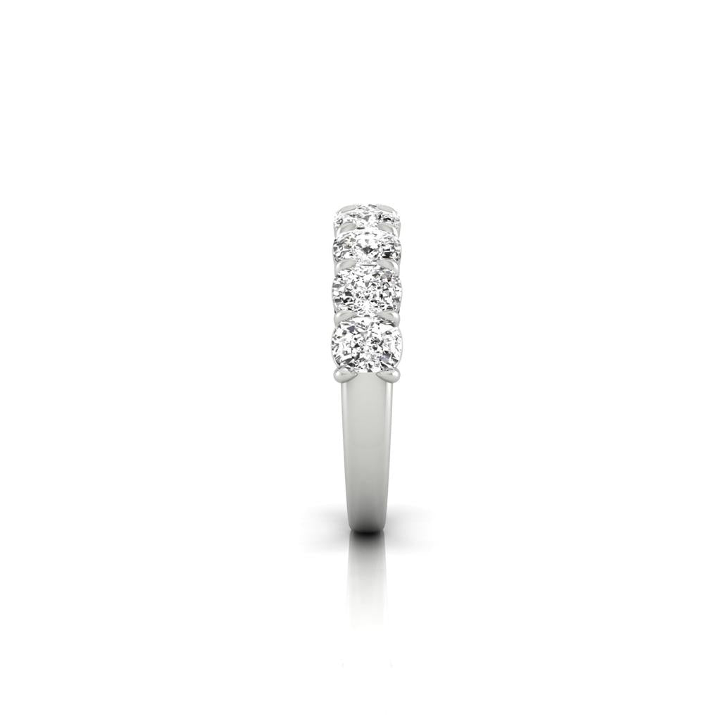 The Half Lab Grown Diamond Eternity Ring is showcased against a plain white background, featuring lab-grown diamonds elegantly set along the top.