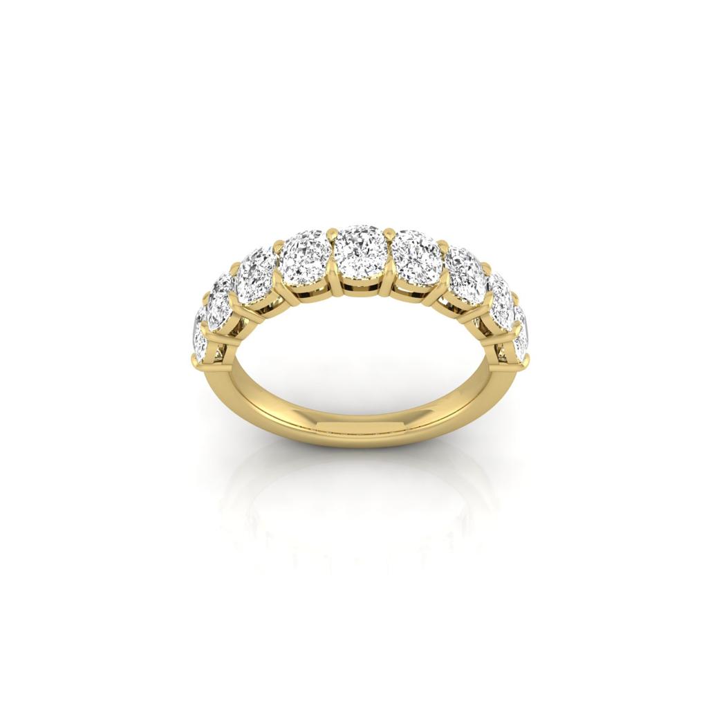 The Half Diamond Eternity Ring is an elegant 18KT gold piece, featuring a continuous band of sparkling VS clarity diamonds. Positioned upright and centered on a plain white background, it embodies timeless beauty.