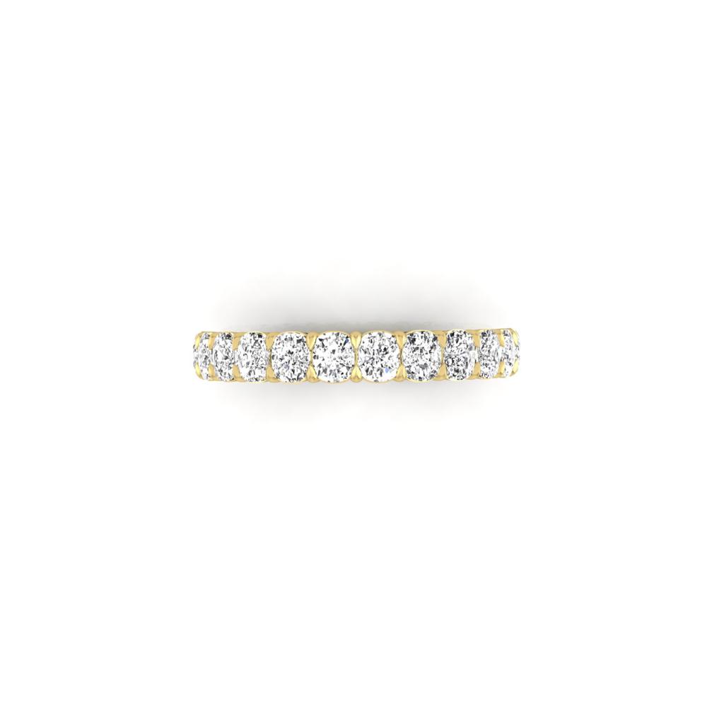 The Half Diamond Eternity Ring, crafted from 18KT gold, features a row of round diamonds with VS clarity elegantly set on top. The sleek design exudes sophistication against a plain white background.
