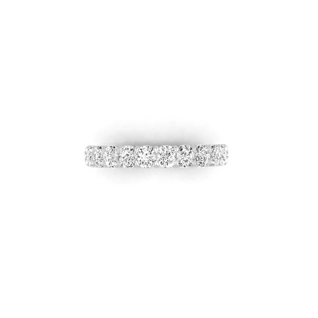 The Half Lab Grown Diamond Eternity Ring showcases a row of round, brilliant lab-grown diamonds set on a sleek silver band, elegantly presented against a simple white backdrop.