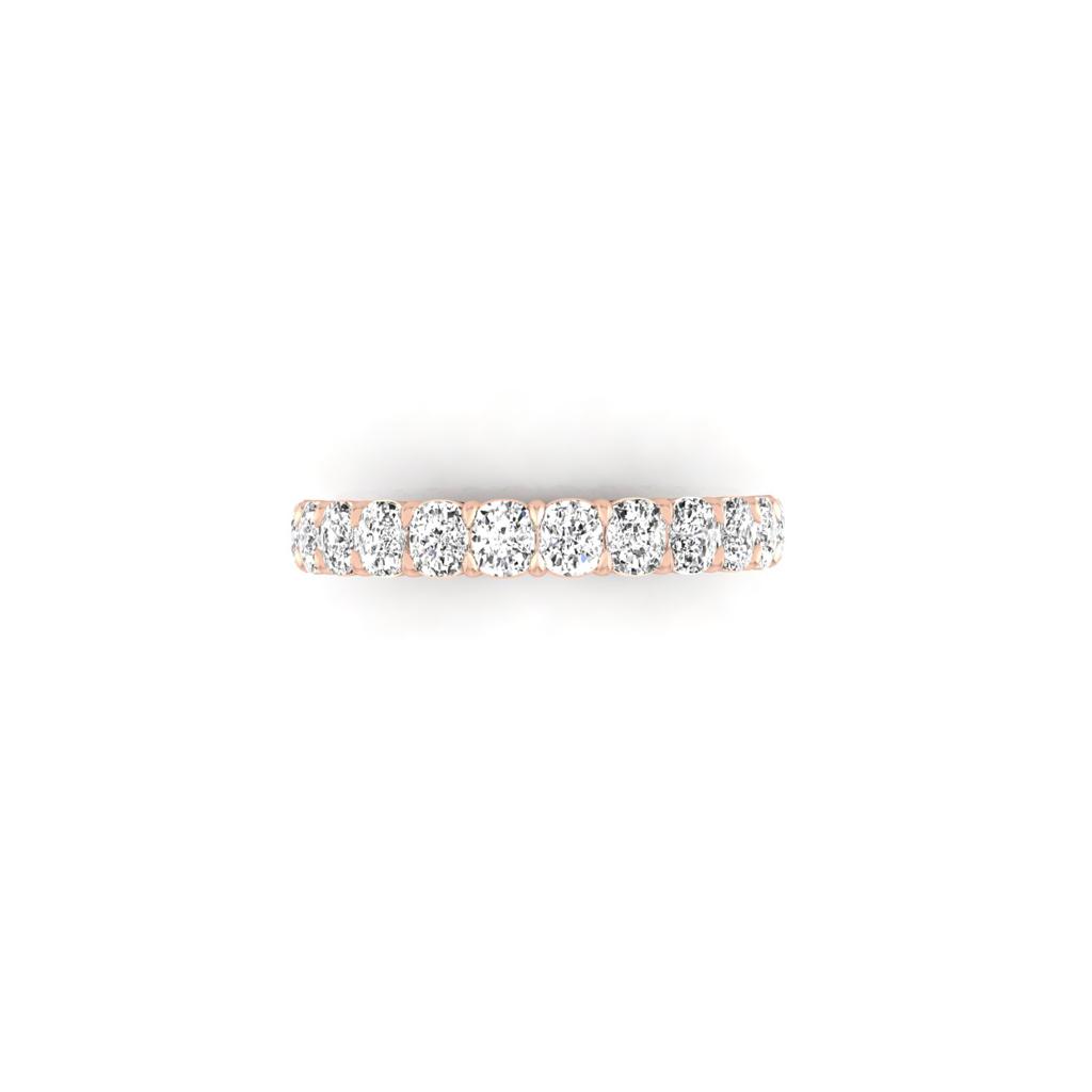 The Half Lab Grown Diamond Eternity Ring, made with 18KT rose gold, features a sleek line of round, sparkling diamonds, elegantly standing out against a plain white background.