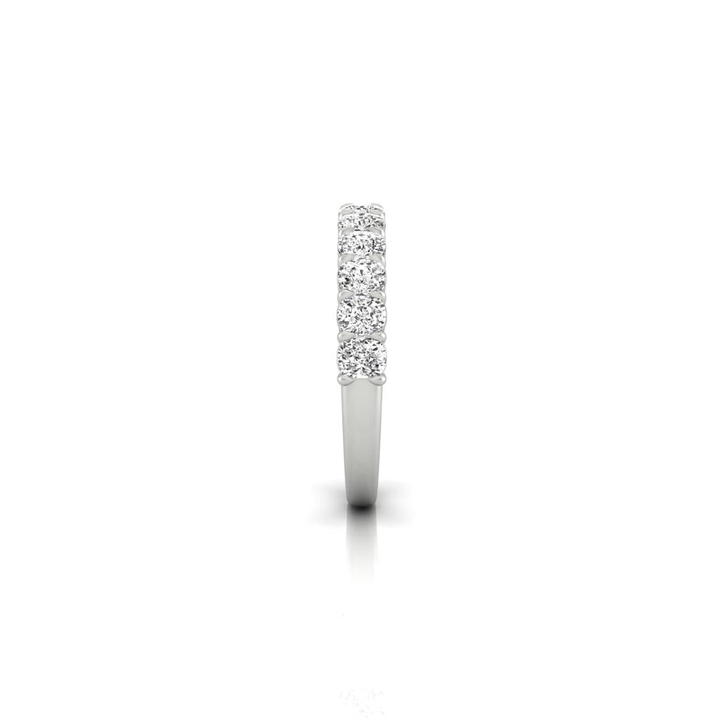 The Half Lab Grown Diamond Eternity Ring, a custom-made silver piece featuring a vertical row of small, round diamonds set along the top half, is displayed against a plain white background, reflecting genuine diamond details.