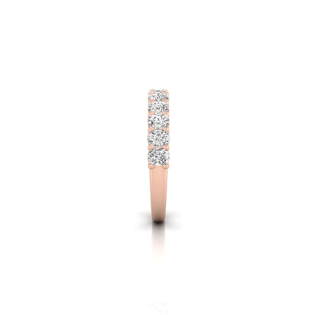 Side view of the Half Diamond Eternity Ring in 18KT rose gold, adorned with a row of six small VS clarity diamonds set in a straight line, displayed on a white background to accentuate its elegant and minimalist design.