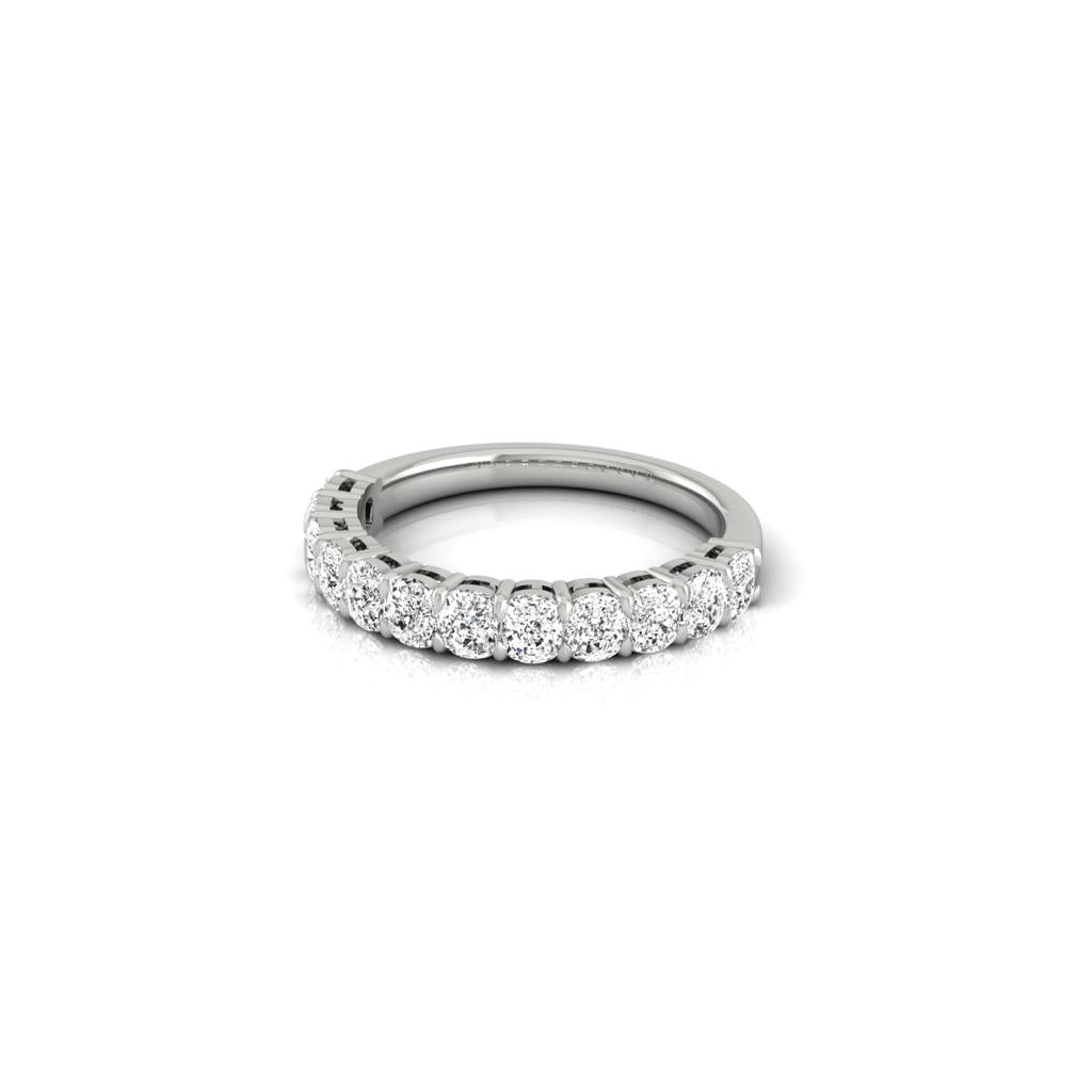 The Half Lab Grown Diamond Eternity Ring, crafted in silver with a row of small, round, sparkling diamonds adorning the upper half, is displayed on a white background.