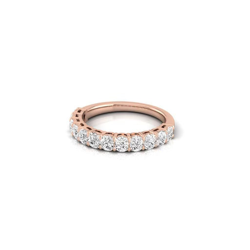 The Half Diamond Eternity Ring features rose gold 18KT with a row of round, sparkling VS clarity diamonds in a shared prong setting, covering half the band for an elegant and shimmering look.